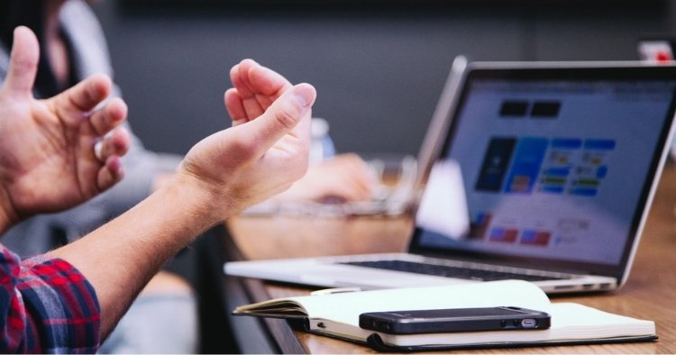 Two people working and actively talking to each other