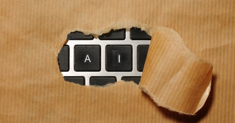 Cut-out of cardboard revealing the AI underneath on a keyboard