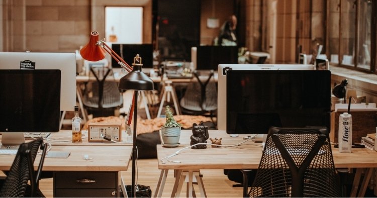 Business office with desks and computers representing the use of this new technology in the workplace