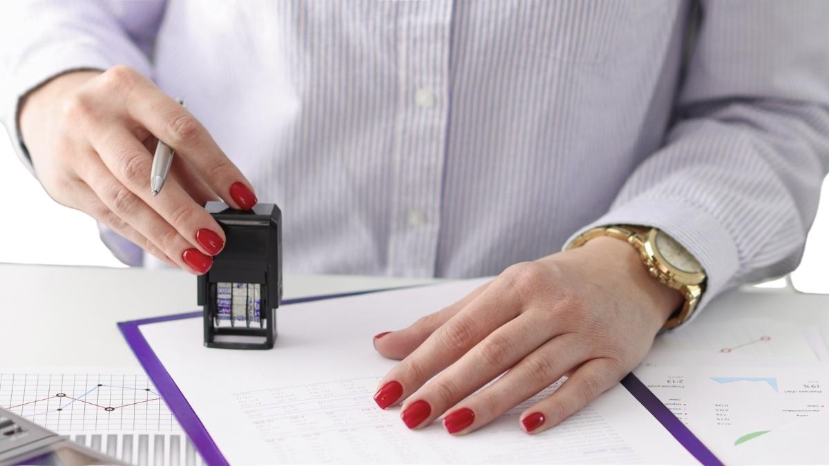 Woman stamping official-looking paperwork