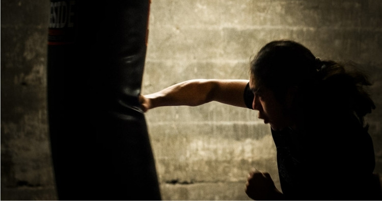 Man hitting a punching bag representing cybersecurity
