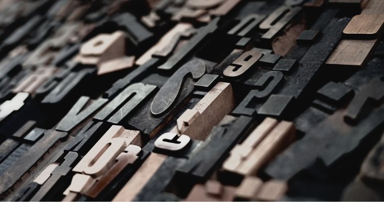 Wooden blocks of letters falling to represent all of the cybersecurity acronyms
