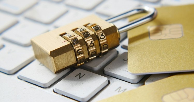 Padlock on keyboard with credit cards showing how cybersecurity protects what's important at your business
