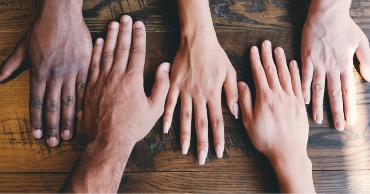 Five hands layed out with all different races representing STACK's diversity