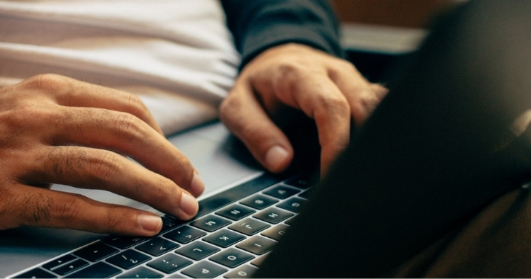 Person typing on a laptop